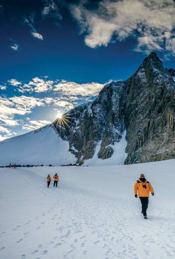 Passengers hiking in Antarctic Landscape