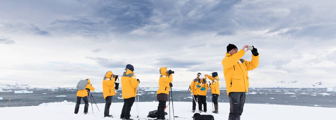 Guests enjoying Antarctic landscapes on a landing at Portal Point. Photo by Sam Edmonds.