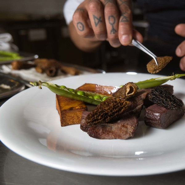 Dry-salted caribou with pommes fondant, morels, peas and banquet sauce