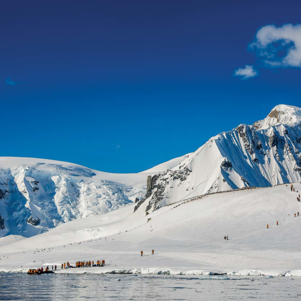 Passengers exiting Zodiac and hiking in the Antarctic