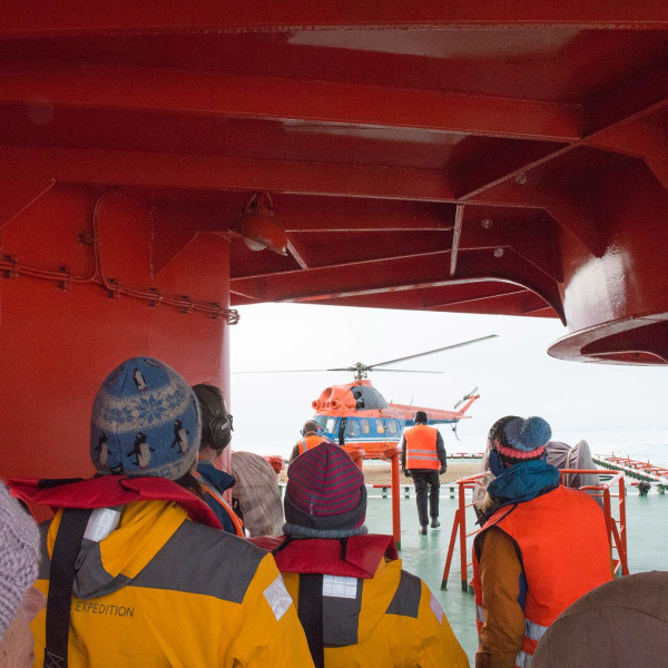 Passengers walking towards helicopter